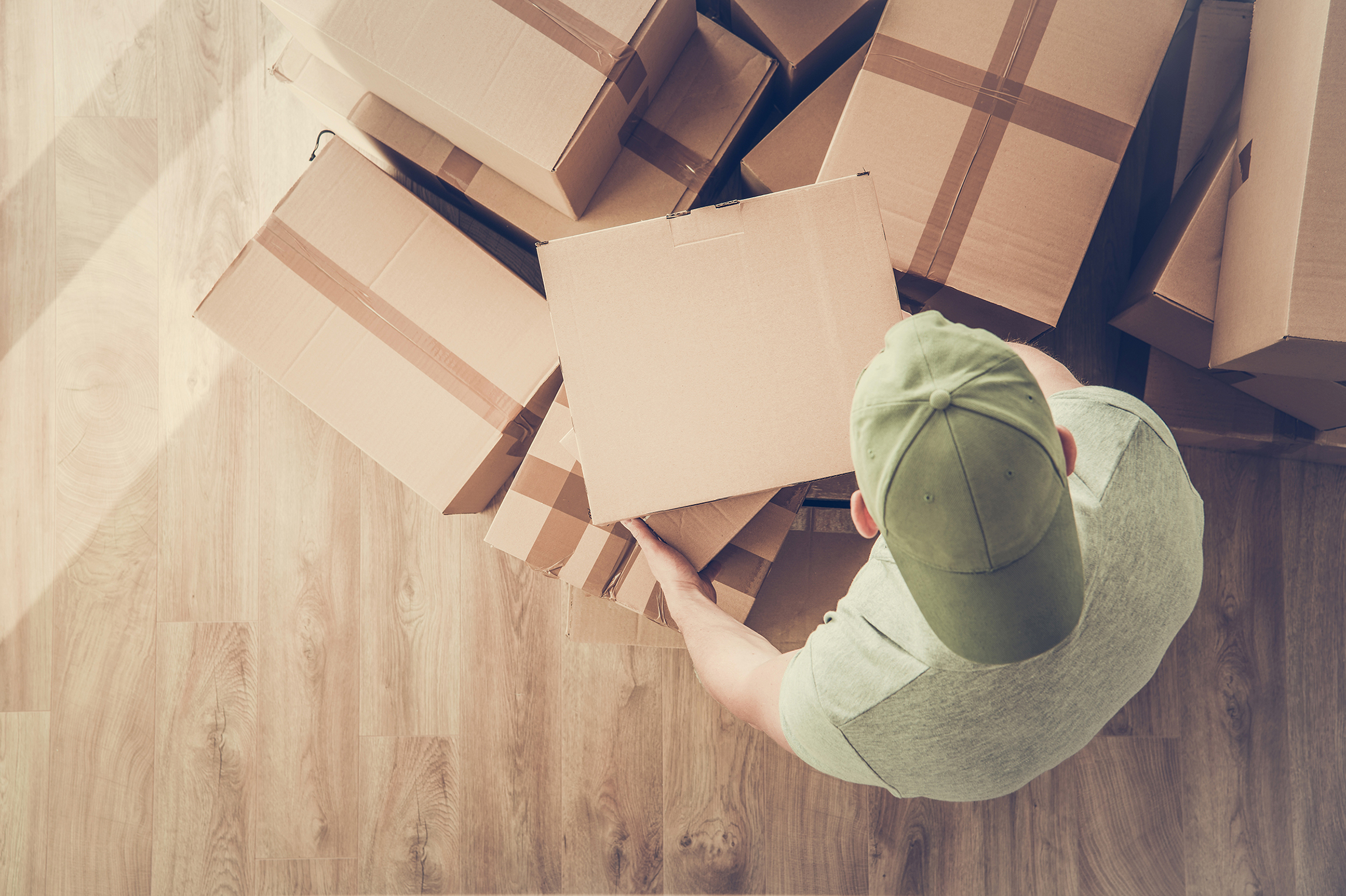 New Rental Apartment Moving In. Caucasian Men Carrying Cardboard Boxes with Personal Stuff.